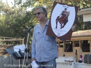 Mark Goldschmidt holds mock-up of heritage district sign